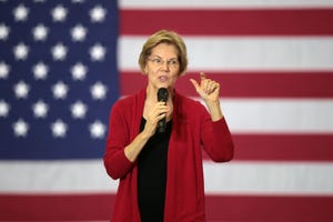 elizabeth warren in front of flag