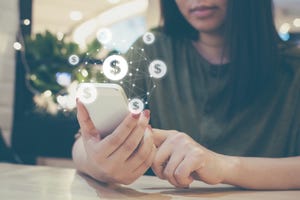 woman using phone to make mobile payments