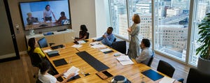 Business people video conferencing in a conference room meeting