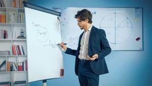 person writing on a whiteboard