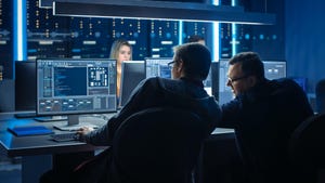 employees at desktops in control room