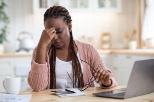 frustrated worker sitting at her computer