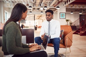 job interview in seating area of modern office