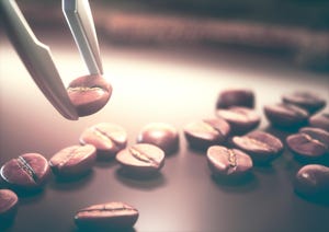 tweezers remove a coffee bean from a group of coffee beans