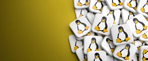 logos of linux penguin in a heap on a table