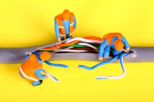 miniature toy workers in orange vests investigating a fault on a broadband network cable