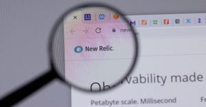 New Relic website being looked at through a magnifying glass