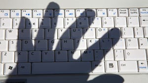 shadow of a hand on a keyboard