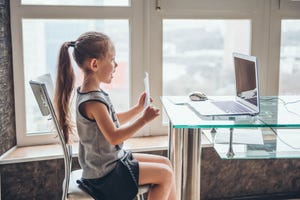 child during an online class troubleshooting remote learning tools